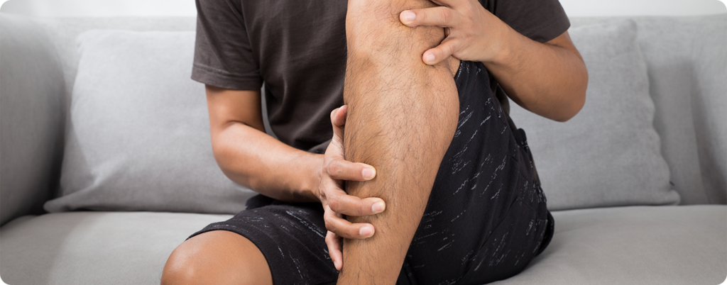 Man dealing with muscle cramps as a result of a low-carb diet. 