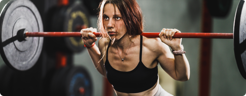 Woman lifting weights in the gym. 