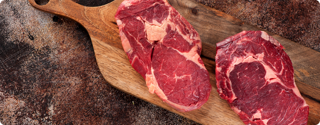 Steaks on a cutting board. 