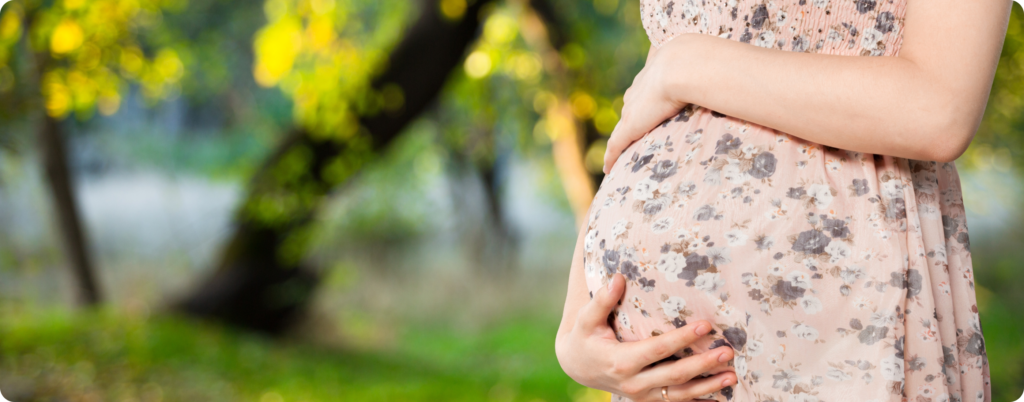 A pregnant woman holding her belly 