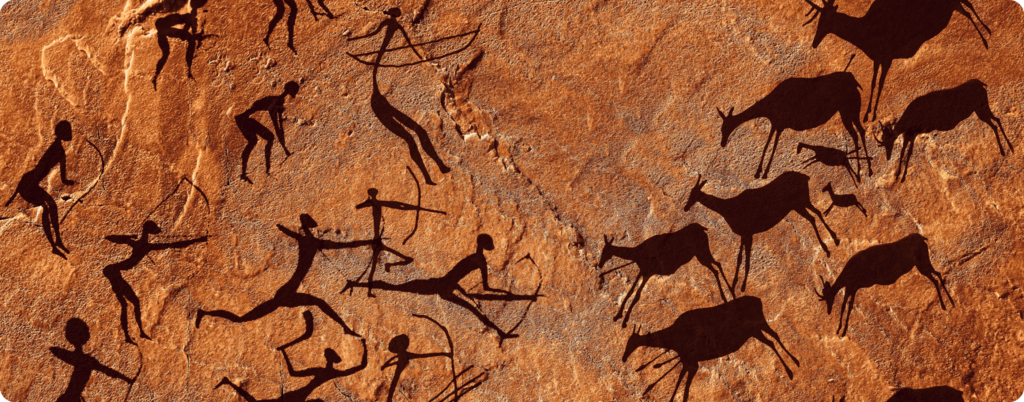 A cave painting of people hunting 