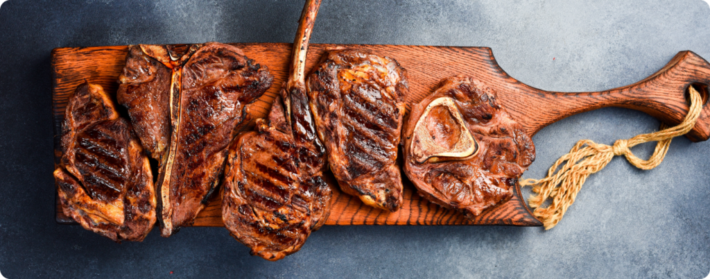 An assortment of steak on a cutting board