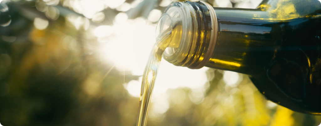 Someone pouring olive oils