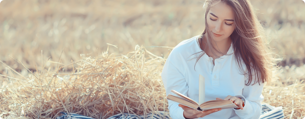 A woman reading in a field