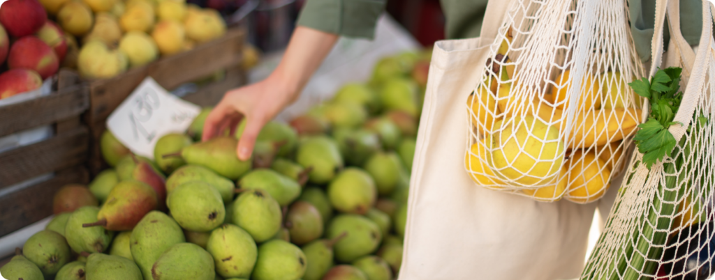 A woman at the farmers market shopping for fruit