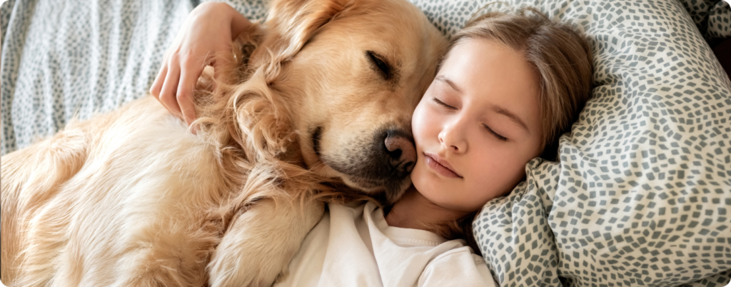 A dog and child sleeping