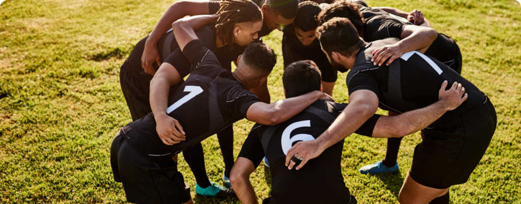 A soccer team huddling up on the field