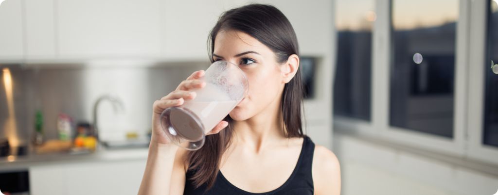 A woman enjoying a protein shake