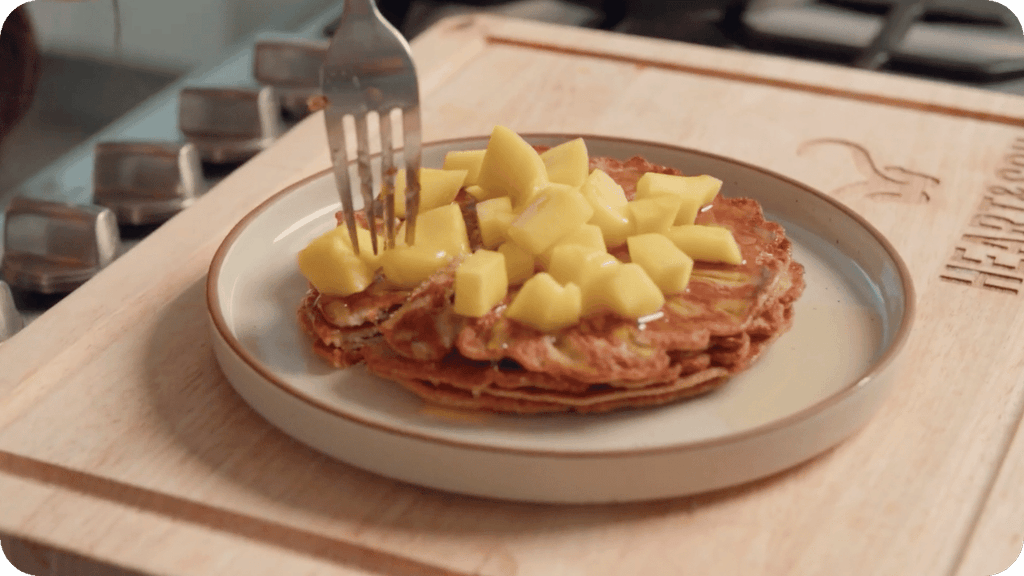top liver pancakes with fresh fruit and maple syrup